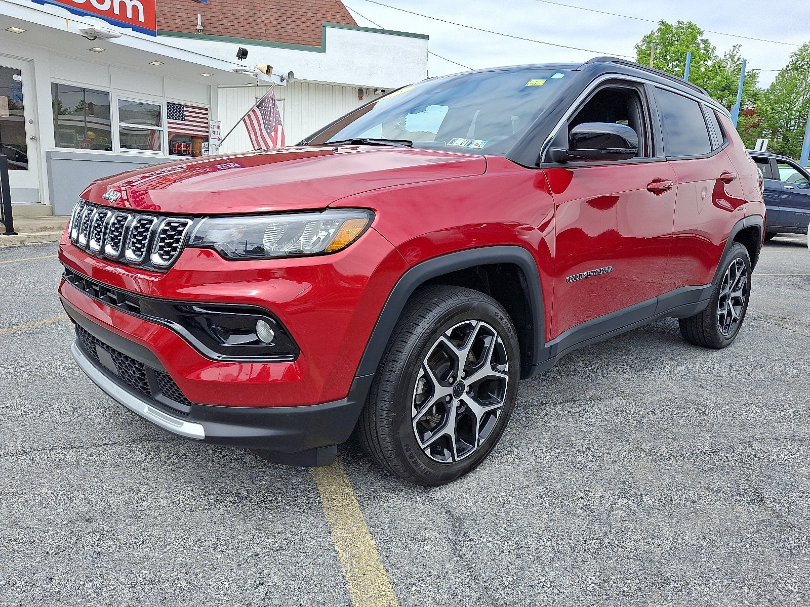 2025 Jeep Compass Limited 4x4 4WD in Red Hot Pearlcoat — front three-quarter view