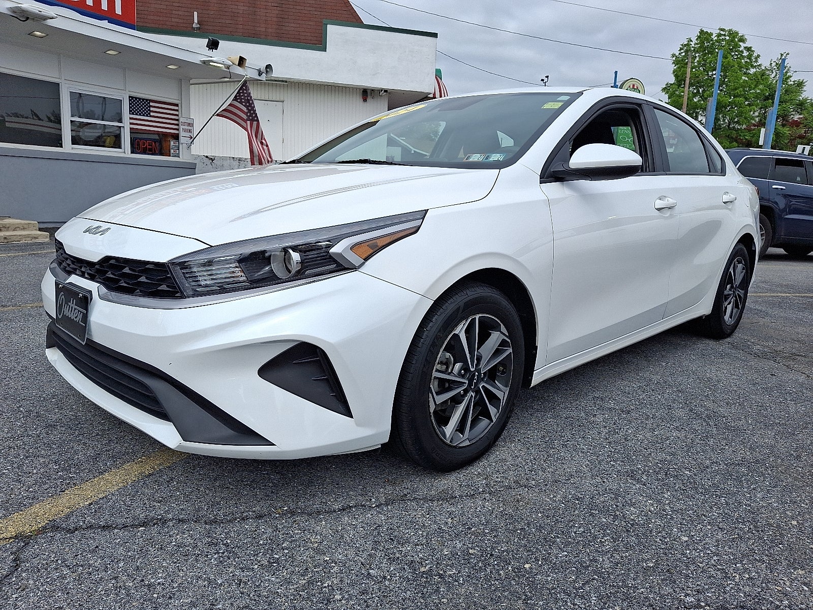 2024 Kia Forte LXS FWD in White — front three-quarter view