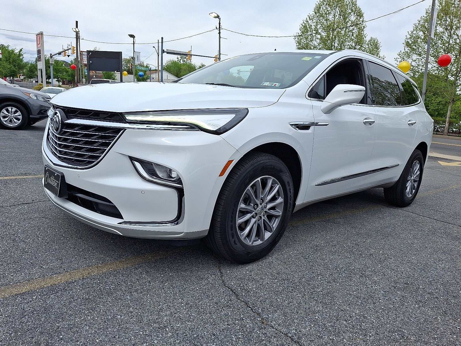 2023 Buick Enclave Essence AWD in Summit White — front three-quarter view