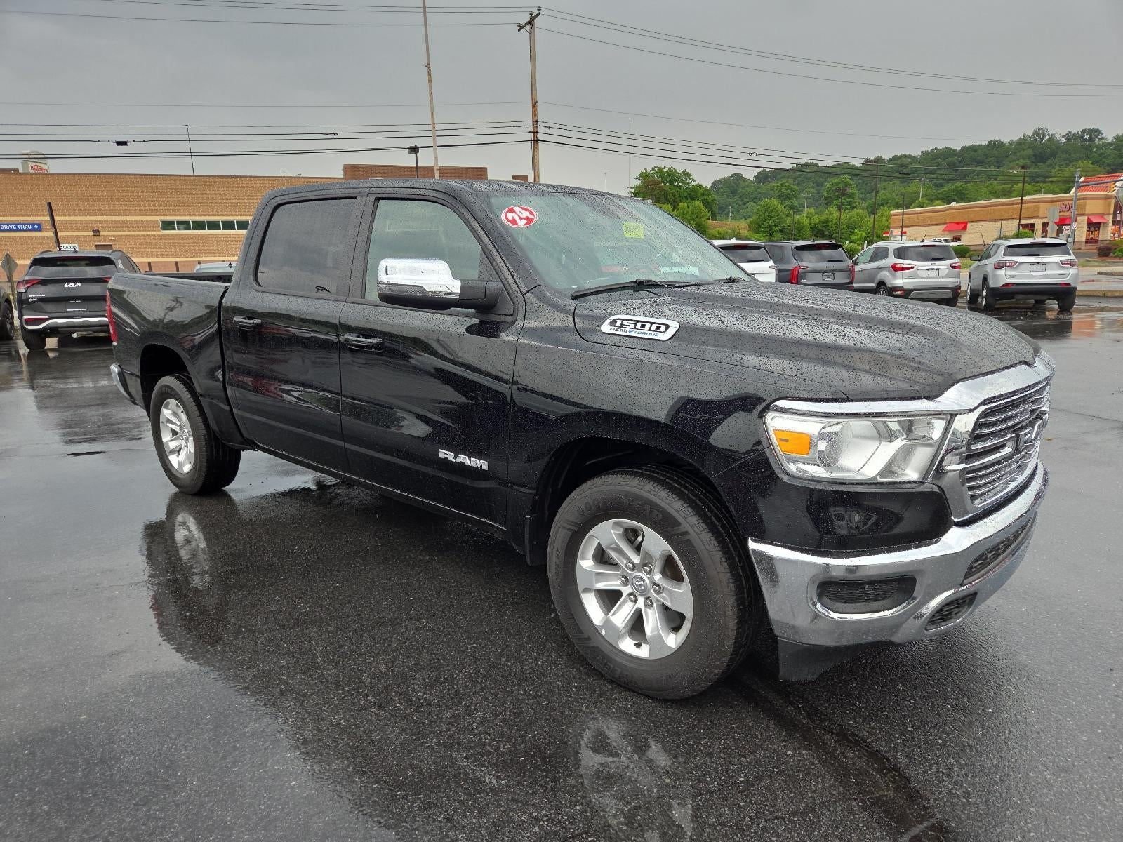 2024 RAM 1500 Laramie 4x4 Crew Cab 5'7" Box in Diamond Black Crystal Pearlcoat — front three-quarter view